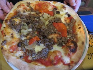 Ric's pizza with minced beef (not done in Italy), onions and marinated red peppers. 