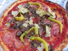 Pizza Zingara with prosciutto, artichokes, spicy salami and mushrooms. Mozzarella and tomato, of course!